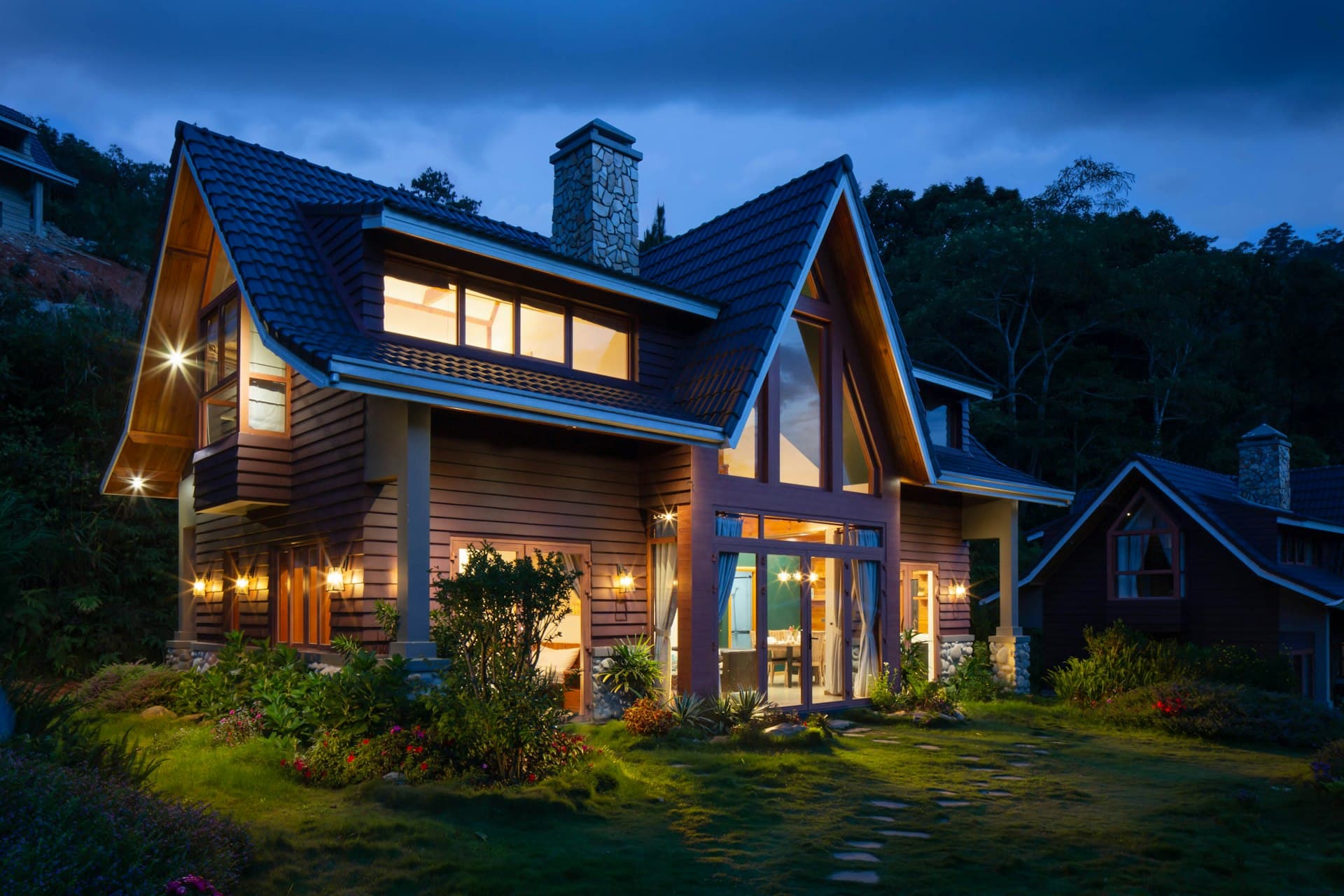 A well-built home lit up at dusk